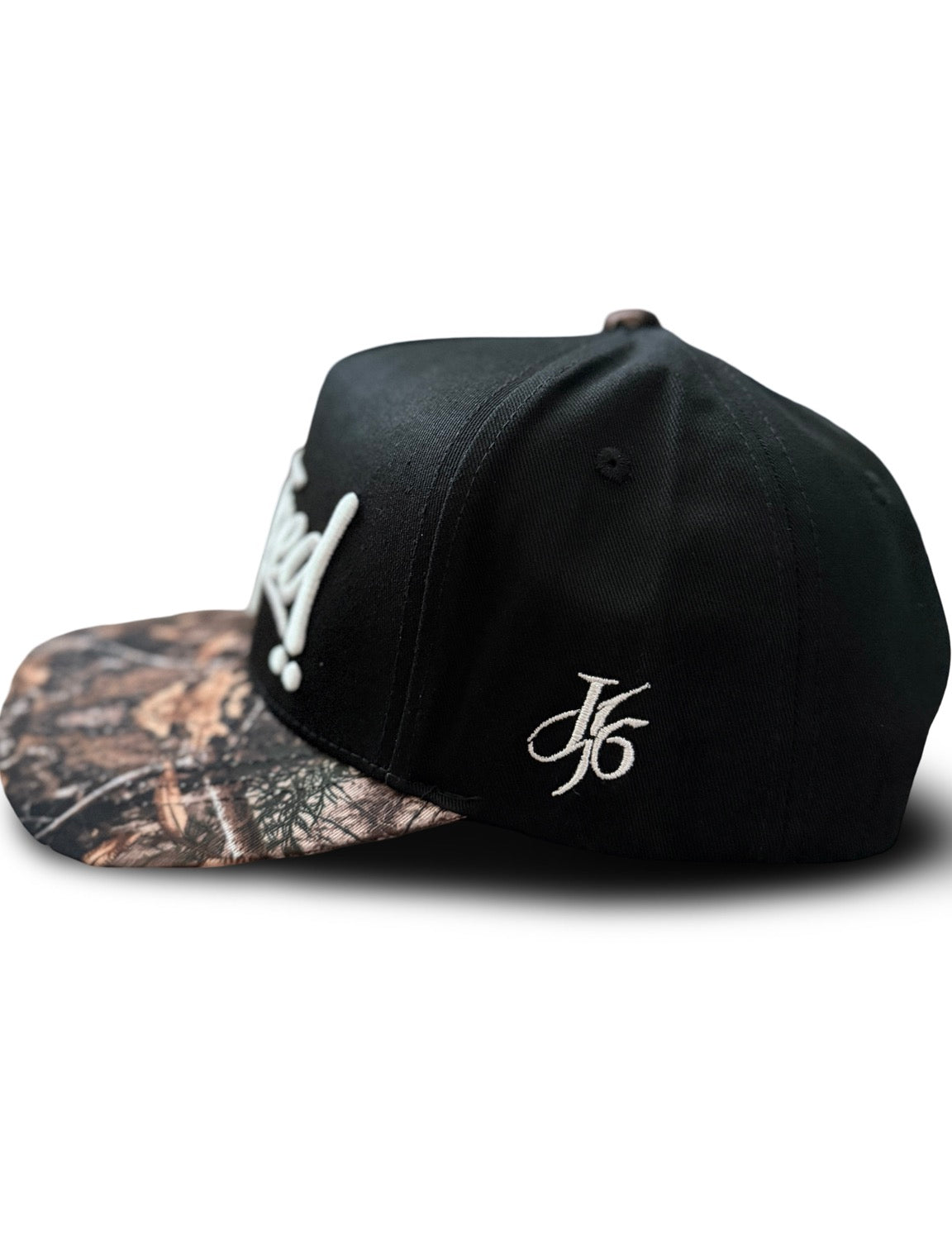 “Strapped” script camo brim snapback